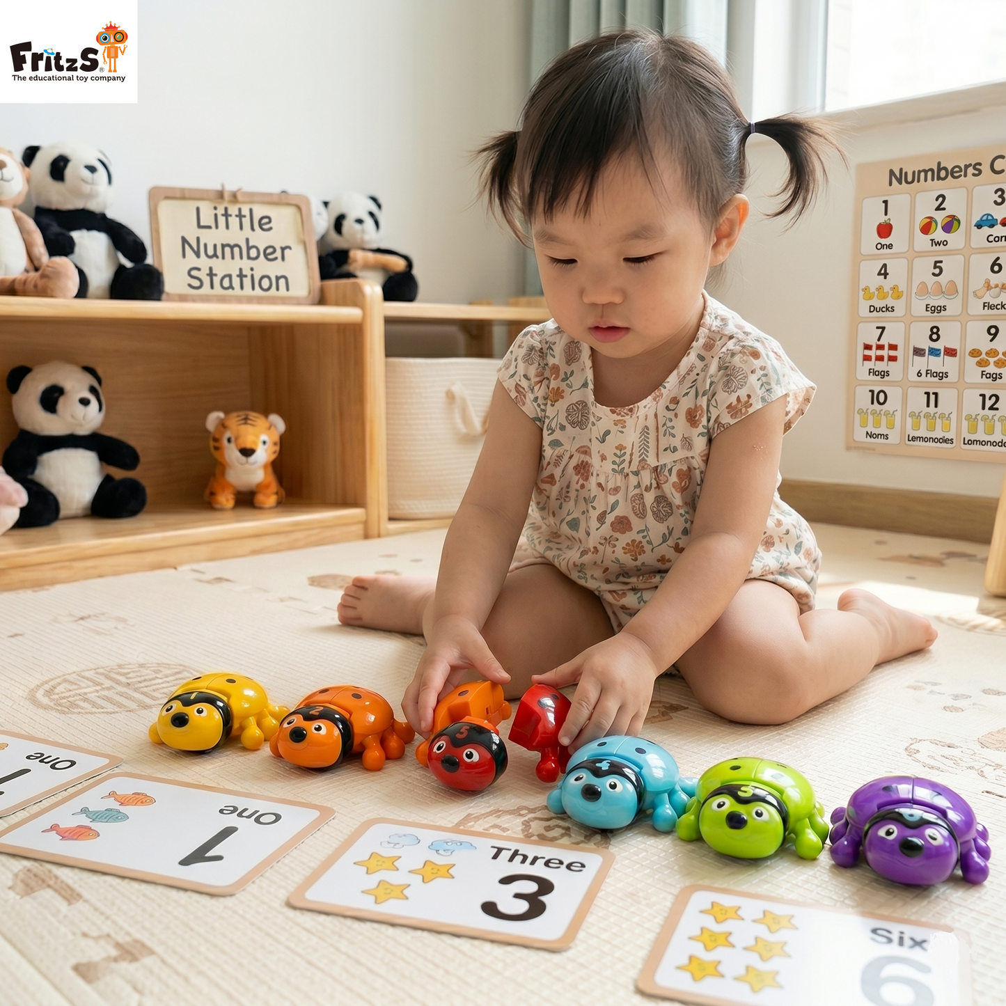 Child playing with colorful FritzS LEC3134 number bugs toys on a mat with number cards in a classroom setting.